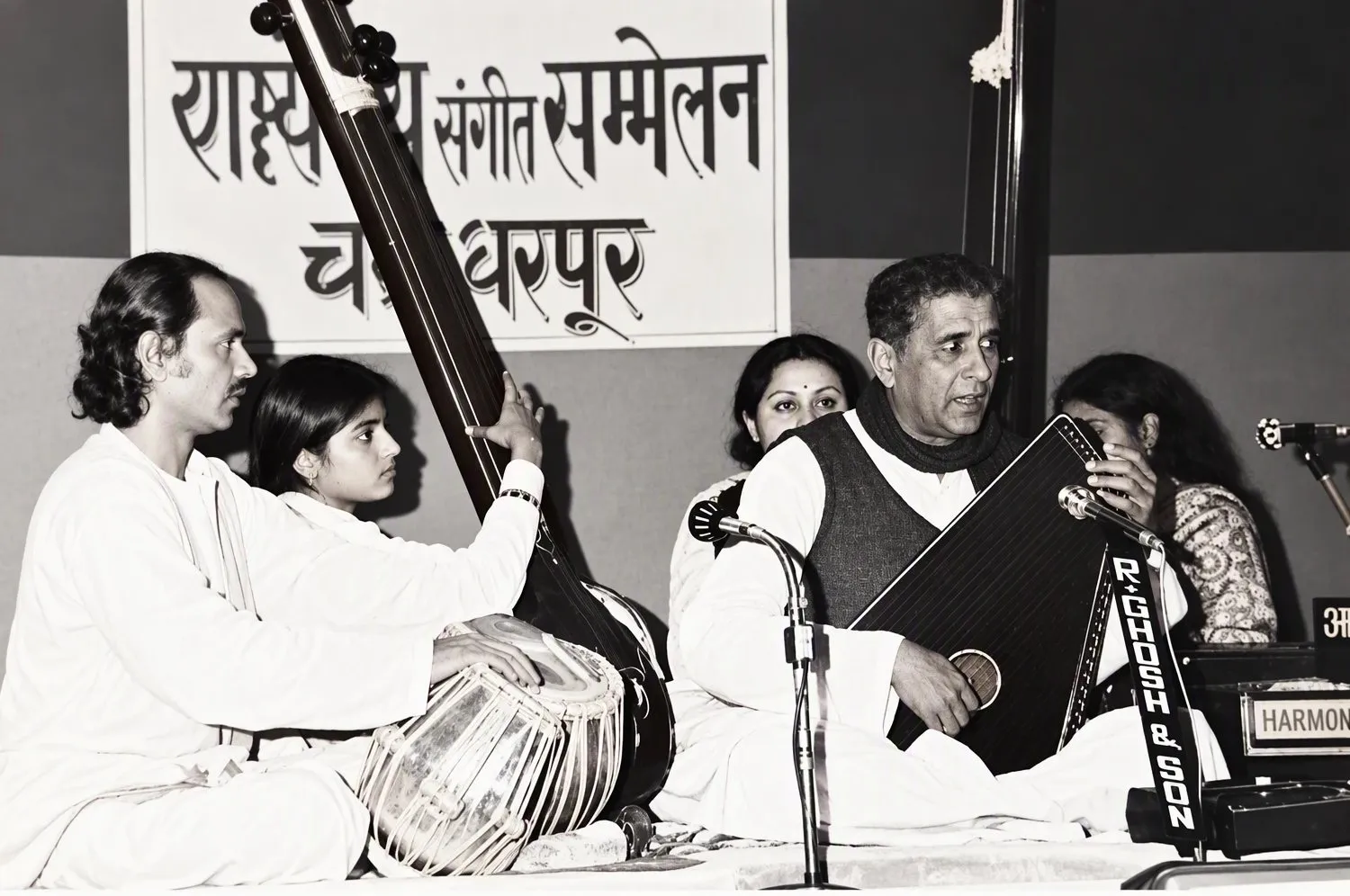 Concert in front of a banner reading Rashtriya Sangeet Sammelan, Chakradharpur: Mihir Bannerjee on tabla at left, Pandit Chandrakant Apte with the swarmandal at right